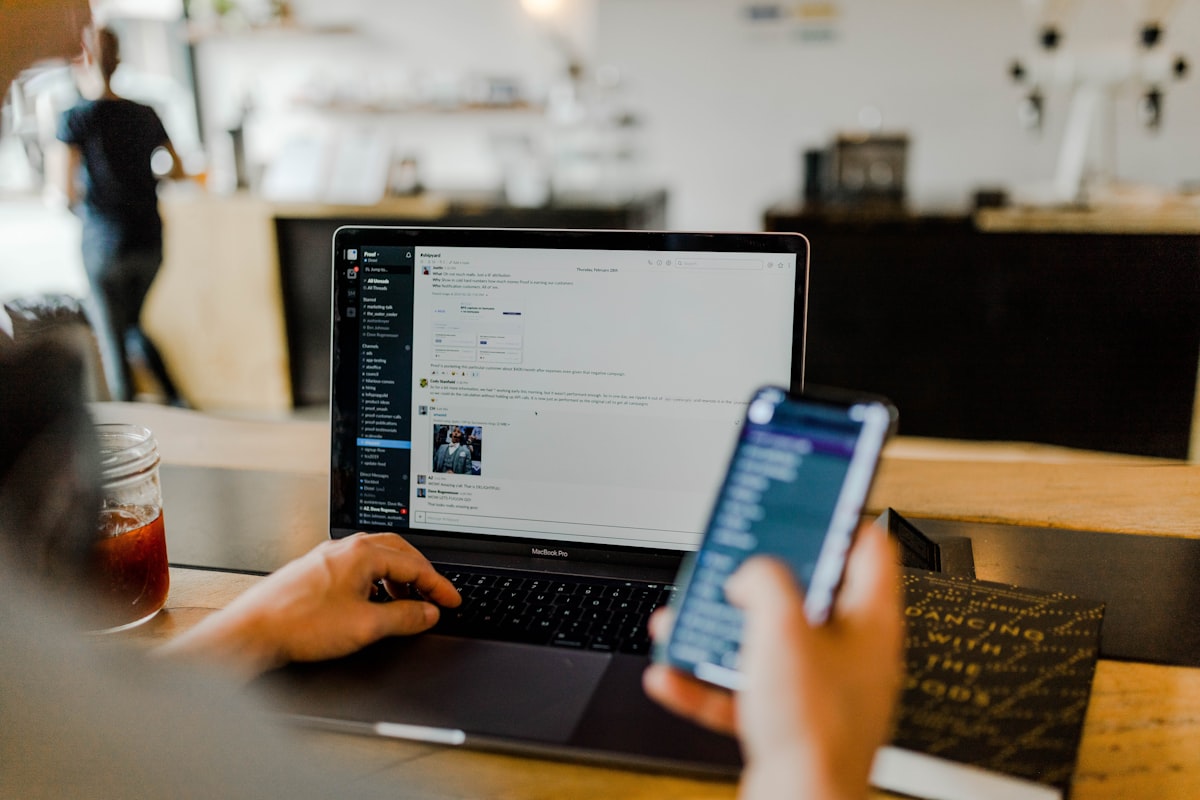 Laptop und Smartphone in den Händen